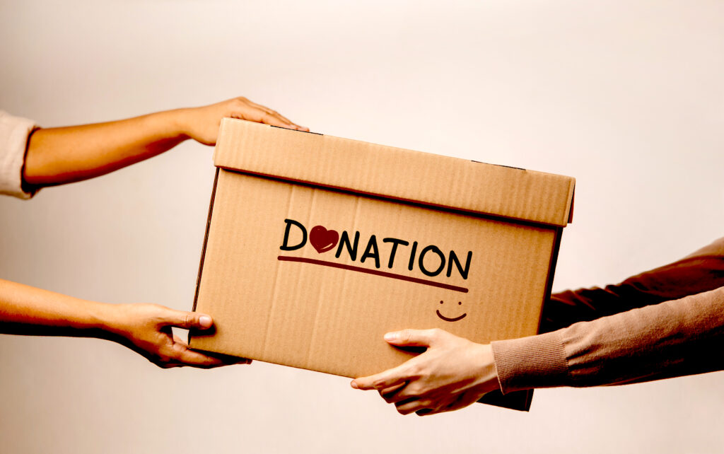The Volunteer Giving a Donate Box to the Recipient.