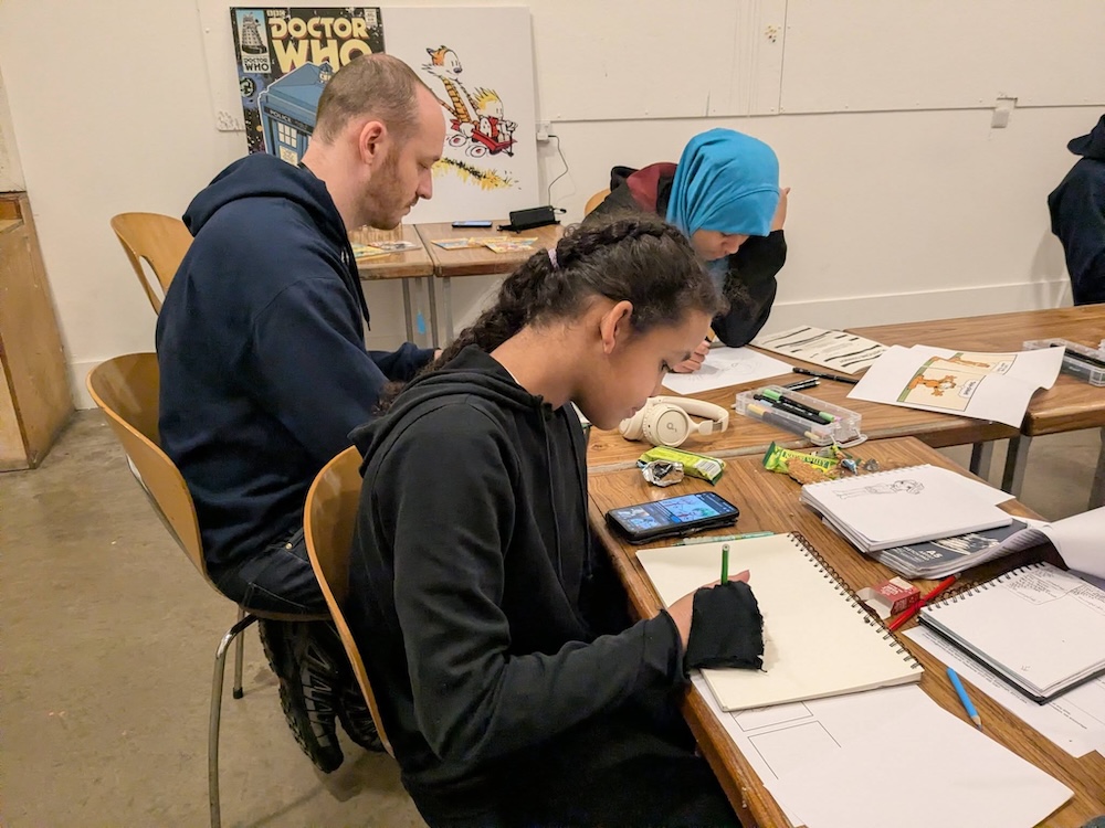 students and teacher illustrating comics