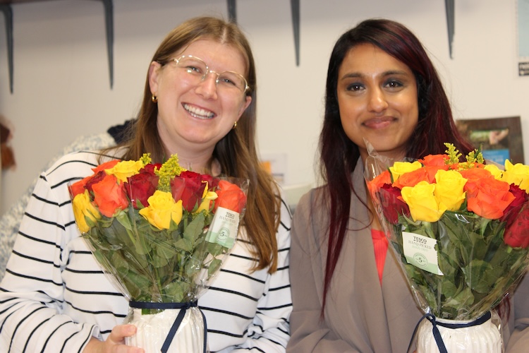 Aisha and Lydia with flowers 2026
